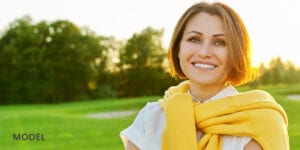 Older Woman in Yellow Sweater Smiling Outdoors